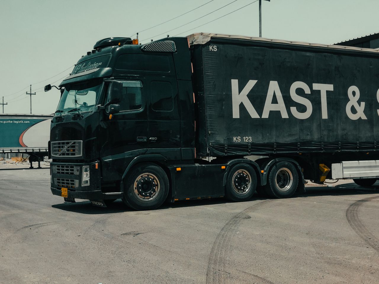 Home A large industrial truck parked in an urban setting, showcasing transportation industry visuals.