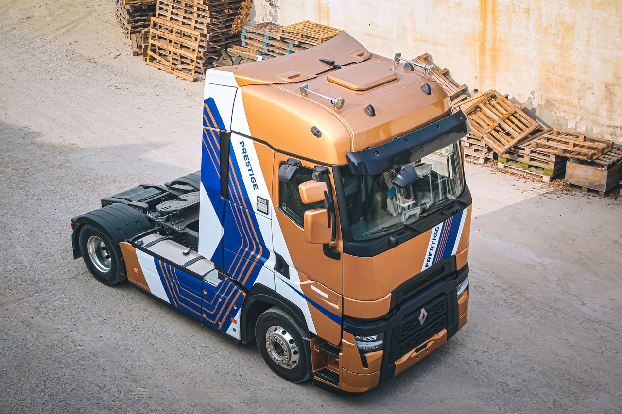 Home Aerial view of a Renault truck in an industrial area with scattered wooden pallets, showcasing modern design.
